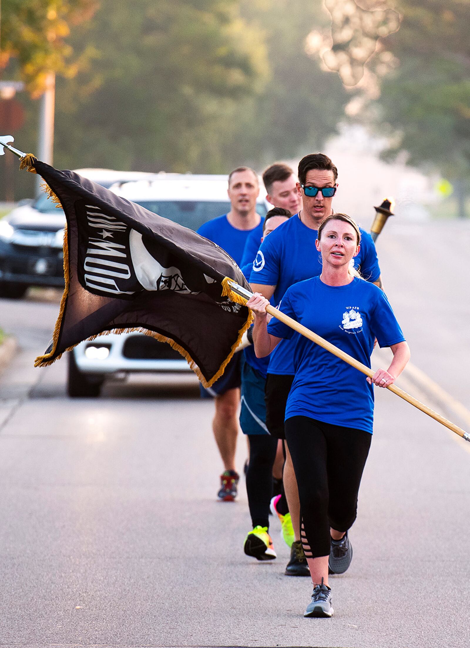 Senior Master Sgt. Elise Redziniak, Air Force Life Cycle Management Center first sergeant, leads a first sergeant delegation on the first leg of the POW/MIA run Sept. 17 at Wright-Patterson Air Force Base. Runners carried the POW/MIA Flag, a torch and scroll over a 6.2-mile course to the base’s POW/MIA Recognition Day wreath-laying ceremony. It was in honor and remembrance of those American service members held captive or missing in action. U.S. AIR FORCE PHOTO/R.J. ORIEZ