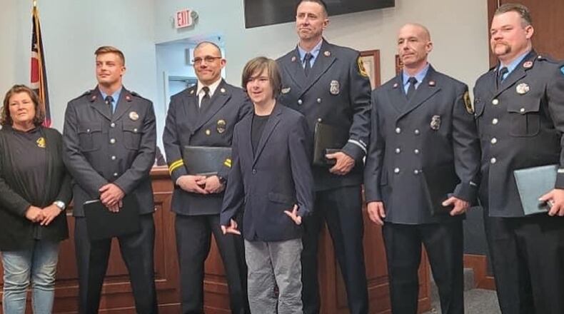 Sean Watson took a photo with the rescue team that saved him from a house fire in March.