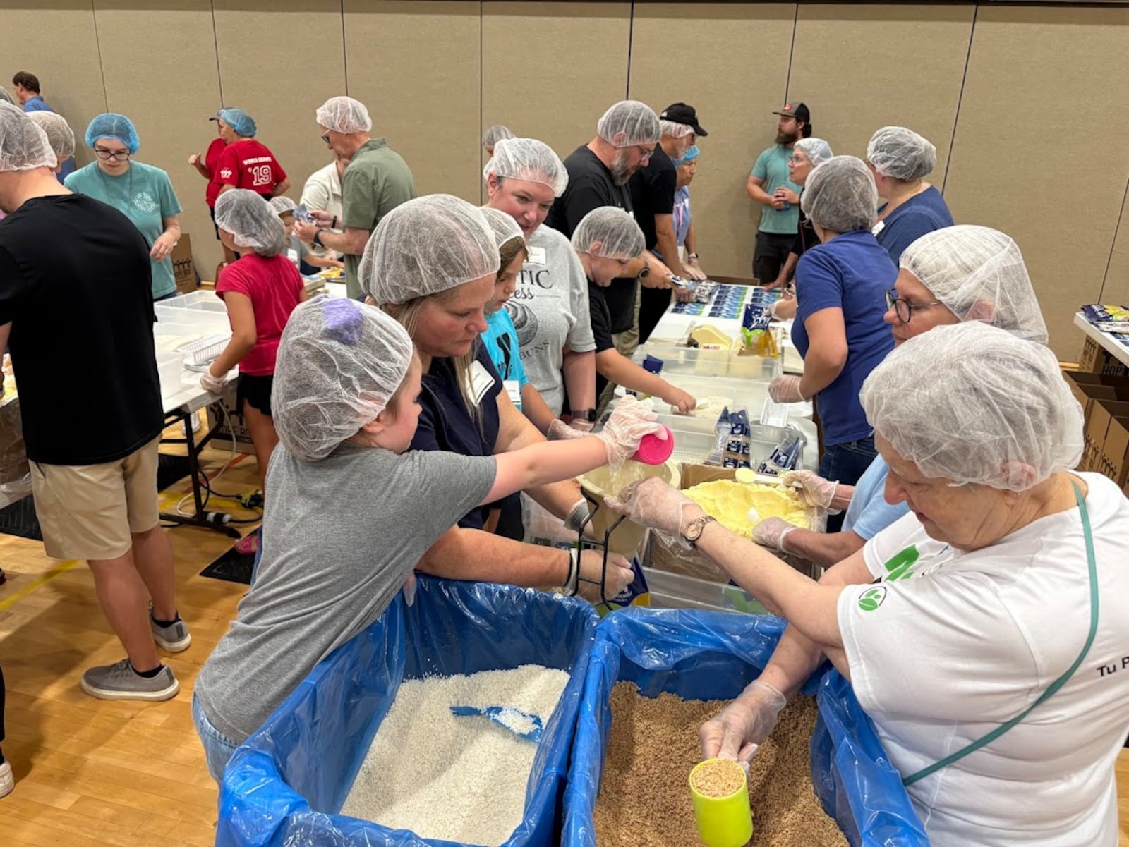 Volunteers package meals for A Child's Hope International at Fairhaven Church's Family Serve Day, on Saturday, Aug. 23, 2025. More than 800 volunteers turned out to package meals and build beds, organizers said. THOMAS GNAU/STAFF