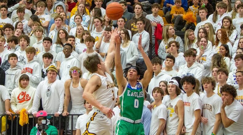 Chaminade Julienne's Evan Dickey shoots from 3-point range over Alter's Anthony Ruffolo during CJ's 77-70 victory Friday night at Centerville High School. Dickey made four 3-pointers and scored 20 points. CONTRIBUTED/Jeff Gilbert