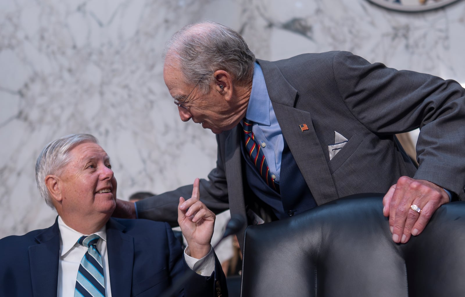 Senate Judiciary Committee Chairman Chuck Grassley, R-Iowa, right, greets Sen. Lindsey Graham, R-S.C., as the panel meets to advance President Donald Trump's nominees for the federal bench, including Emil Bove, Trump's former defense lawyer, at the Capitol in Washington, Thursday, July 17, 2025. (AP Photo/J. Scott Applewhite)