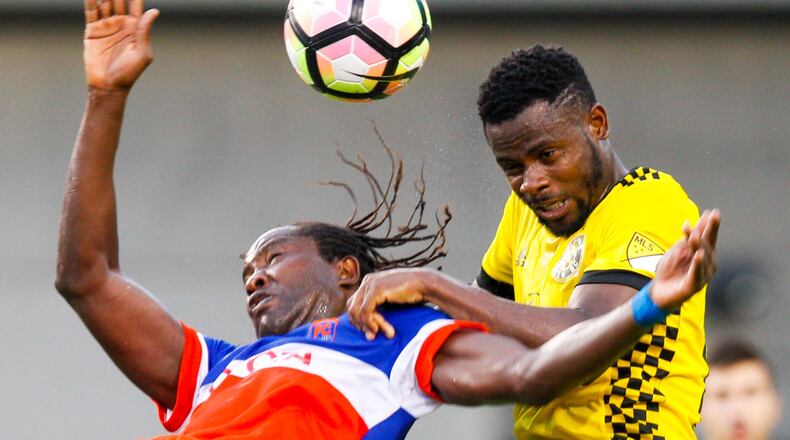 FC Cincinnati forward Djiby Fall (9) and Columbus Crew defender Waylon Francis (14) collide on a header during their Open Cup match held at Nippert Stadium on the campus of the University of Cincinnati, Wednesday, June 14, 2017. GREG LYNCH / STAFF