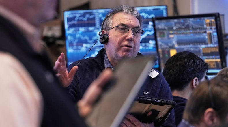 Trader John Bishop works on the floor of the New York Stock Exchange, Friday, Feb. 20, 2026. (AP Photo/Richard Drew)