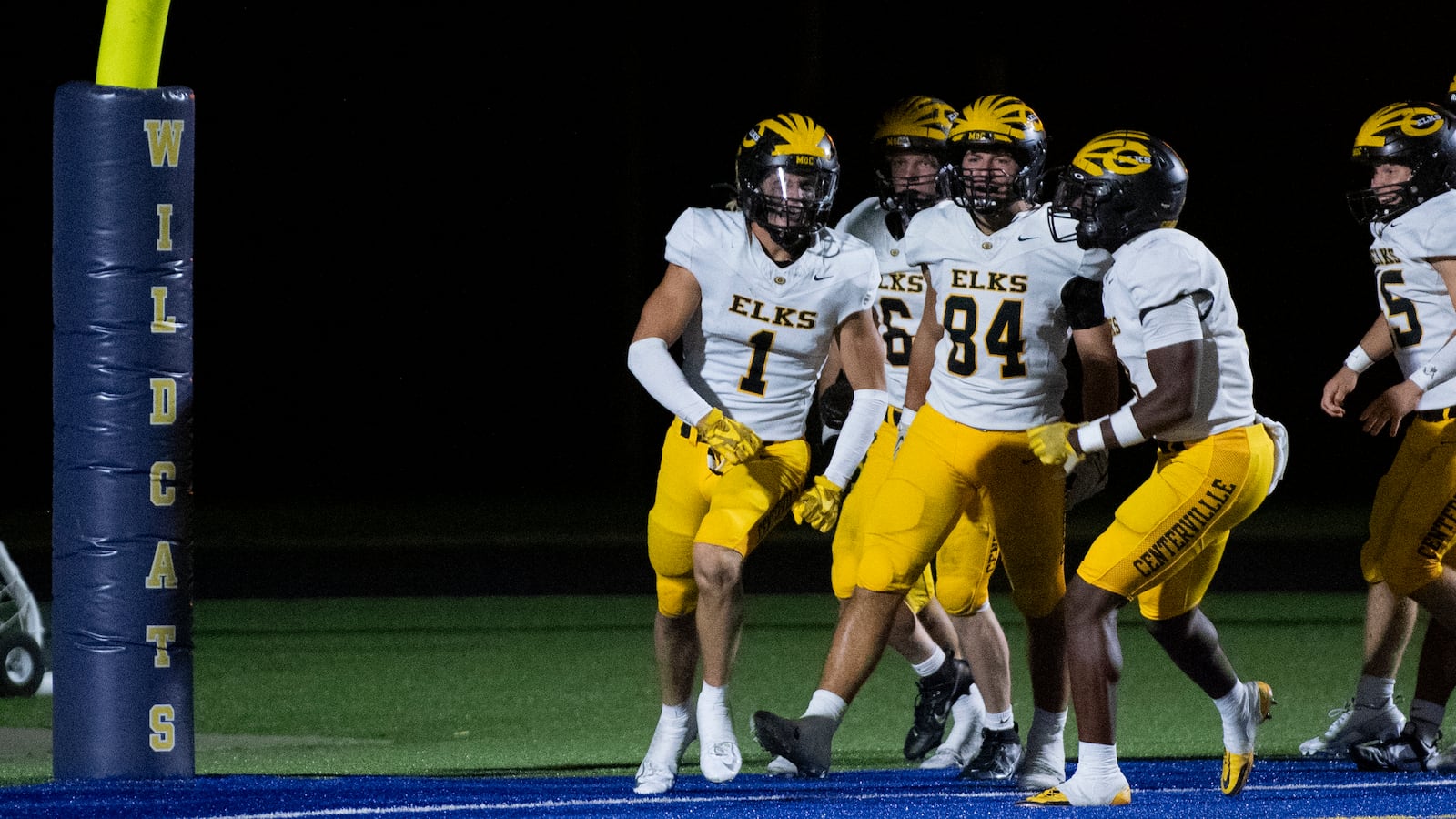 Centerville's Ross Coppock (1) celebrates with his teammates after returning an interception for a touchdown to start the second half Friday night at Springfield. Logan Howard/CONTRIBUTED