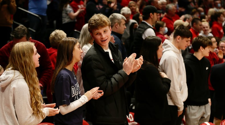 Oakwood junior Will Maxwell, third from left, and Lakota West junior Nathan Dudukovich, second from right, watch Dayton's game against Duquesne on Wednesday, Feb. 9, 2022, at UD Arena. David Jablonski/Staff