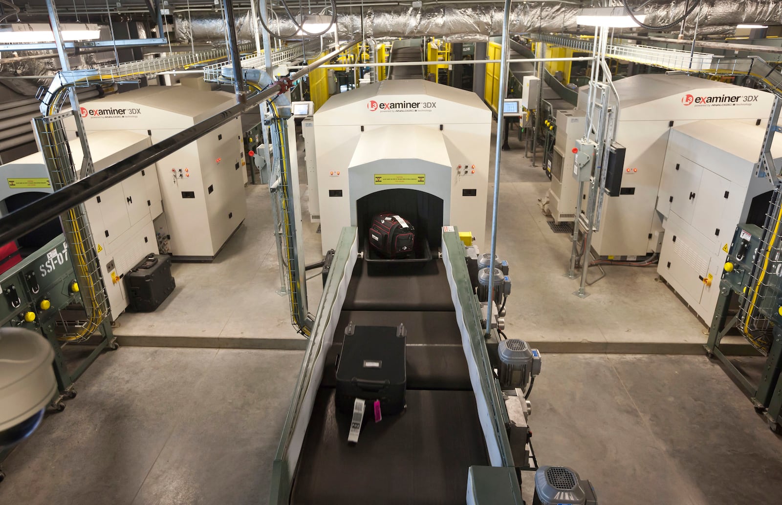 FILE - Air travelers' bags ride a conveyor into one of three new advanced in-line screening machines at Bill and Hillary Clinton National Airport in Little Rock, Ark., Oct. 16 2012. (AP Photo/Danny Johnston, File)