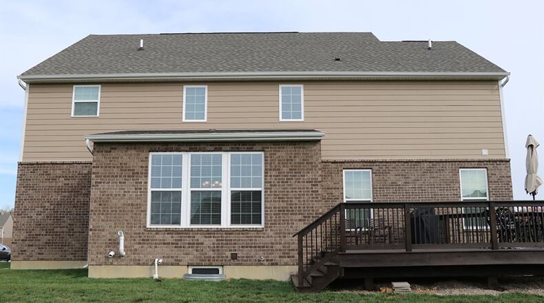 Patio doors open off the breakfast room to the rear deck and open back yard.