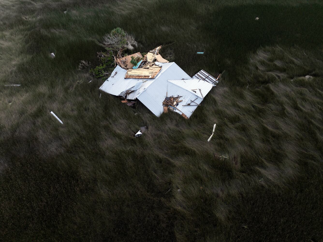 A roof blown away by Hurricane Helene lies in a tidal marsh near the Gulf Coast community of Keaton Beach, Fla., on Saturday, Sept. 28, 2024. (Paul Ratje/The New York Times)