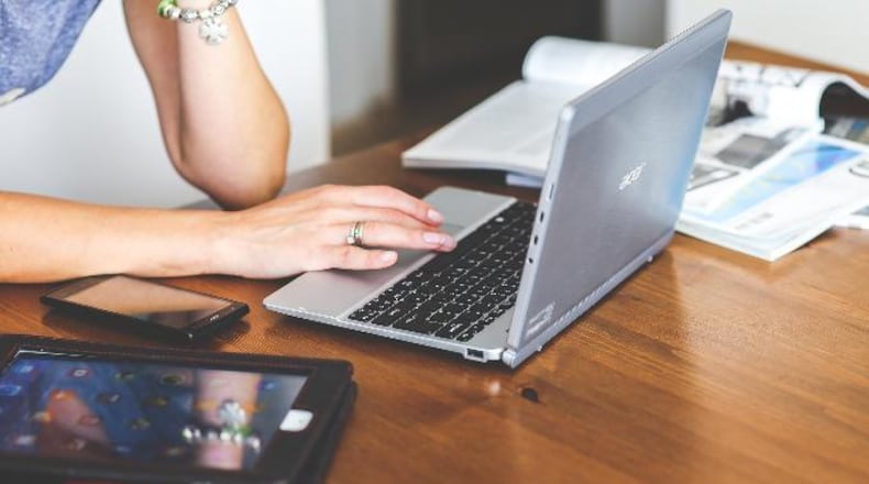 Photo illustration of a woman using a laptop computer.