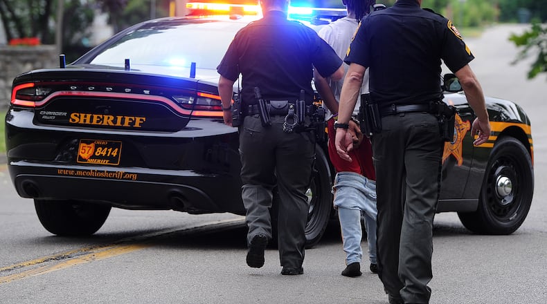 Montgomery County sheriff's deputies and Dayton police held a juvenile at gun point after he was seen running through a neighborhood near North Dixie Drive with a handgun Monday morning June 19, 2023. The juvenile was apprehended hiding in a garden behind a house on Ridge Road. MARSHALL GORBY\STAFF