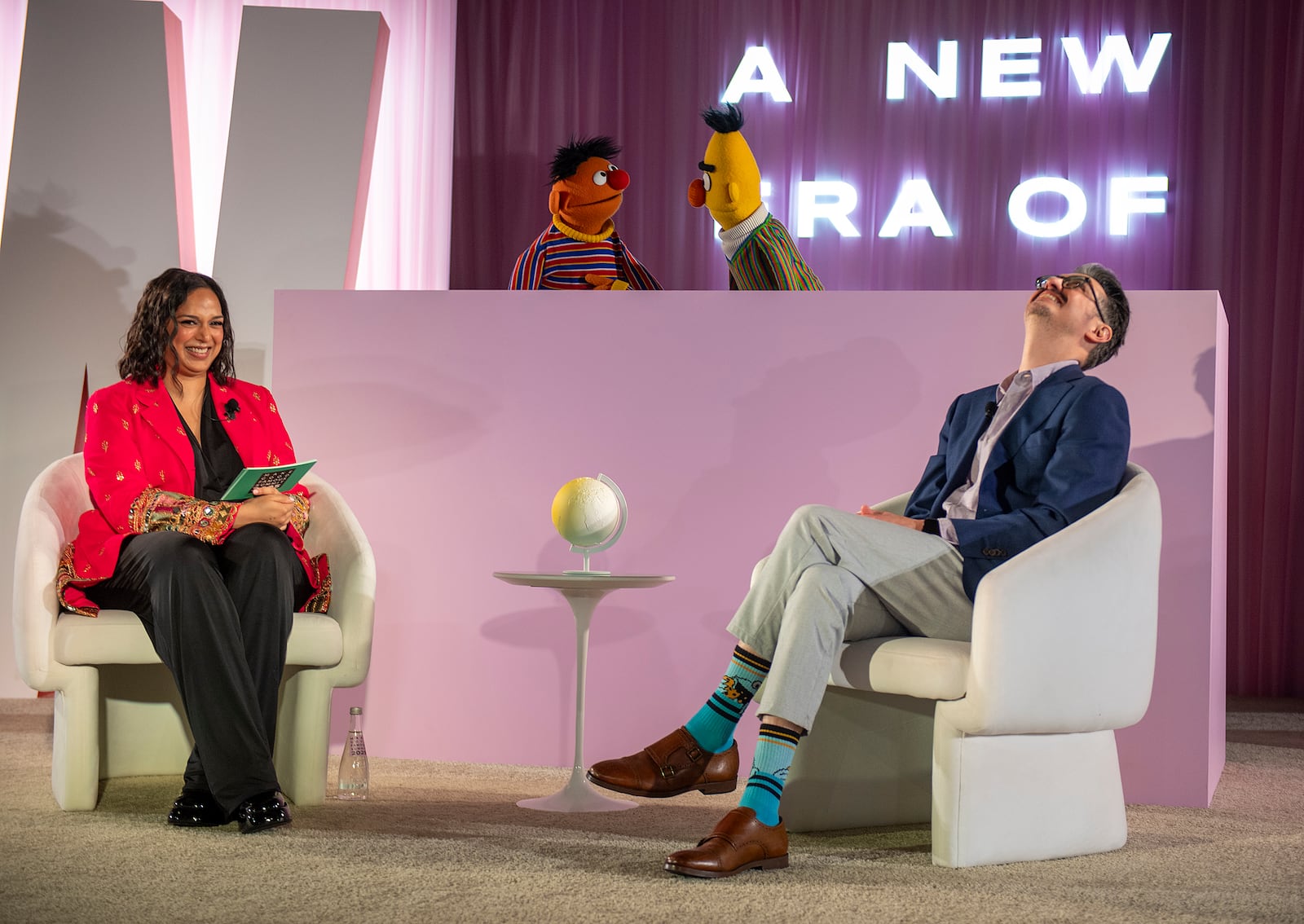 Sal Perez, executive producer and VP of Sesame Street at Sesame Workshop, right, and Versha Sharma, editor-in-chief at Teen Vogue, talk to Burt and Ernie after Sesame Workshop won the Elevate Prize Foundation's Catalyst Award, Wednesday, May 14, 2025, in Miami Beach, Fla. (AP Photo/Michael Laughlin)