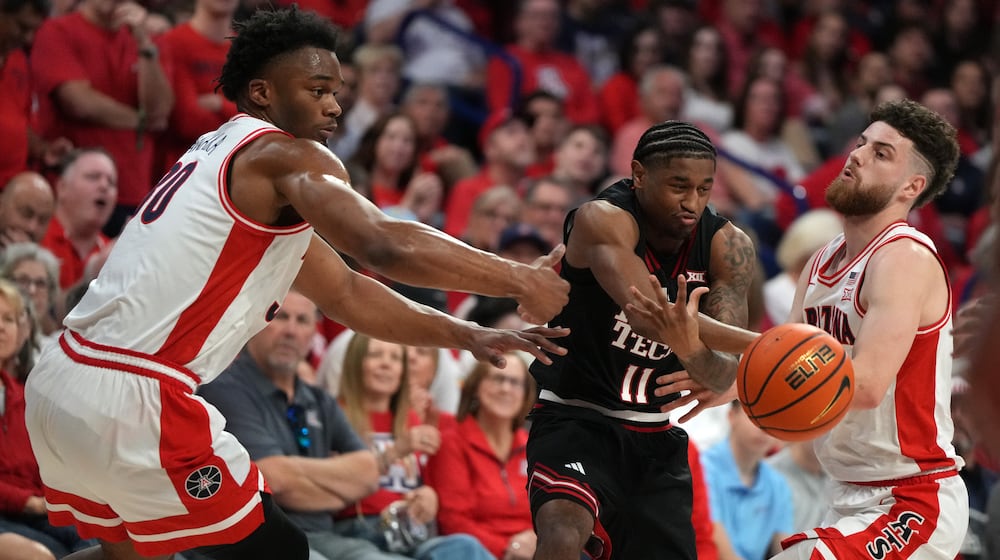 Texas Tech guard Jaylen Petty gets pressured by Arizona forward Tobe Awaka (30) and guard Anthony Dell'orso during the first half of an NCAA college basketball game, Saturday, Feb. 14, 2026, in Tucson, Ariz. (AP Photo/Rick Scuteri)