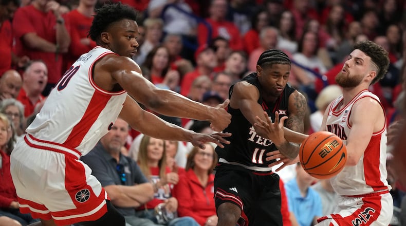 Texas Tech guard Jaylen Petty gets pressured by Arizona forward Tobe Awaka (30) and guard Anthony Dell'orso during the first half of an NCAA college basketball game, Saturday, Feb. 14, 2026, in Tucson, Ariz. (AP Photo/Rick Scuteri)