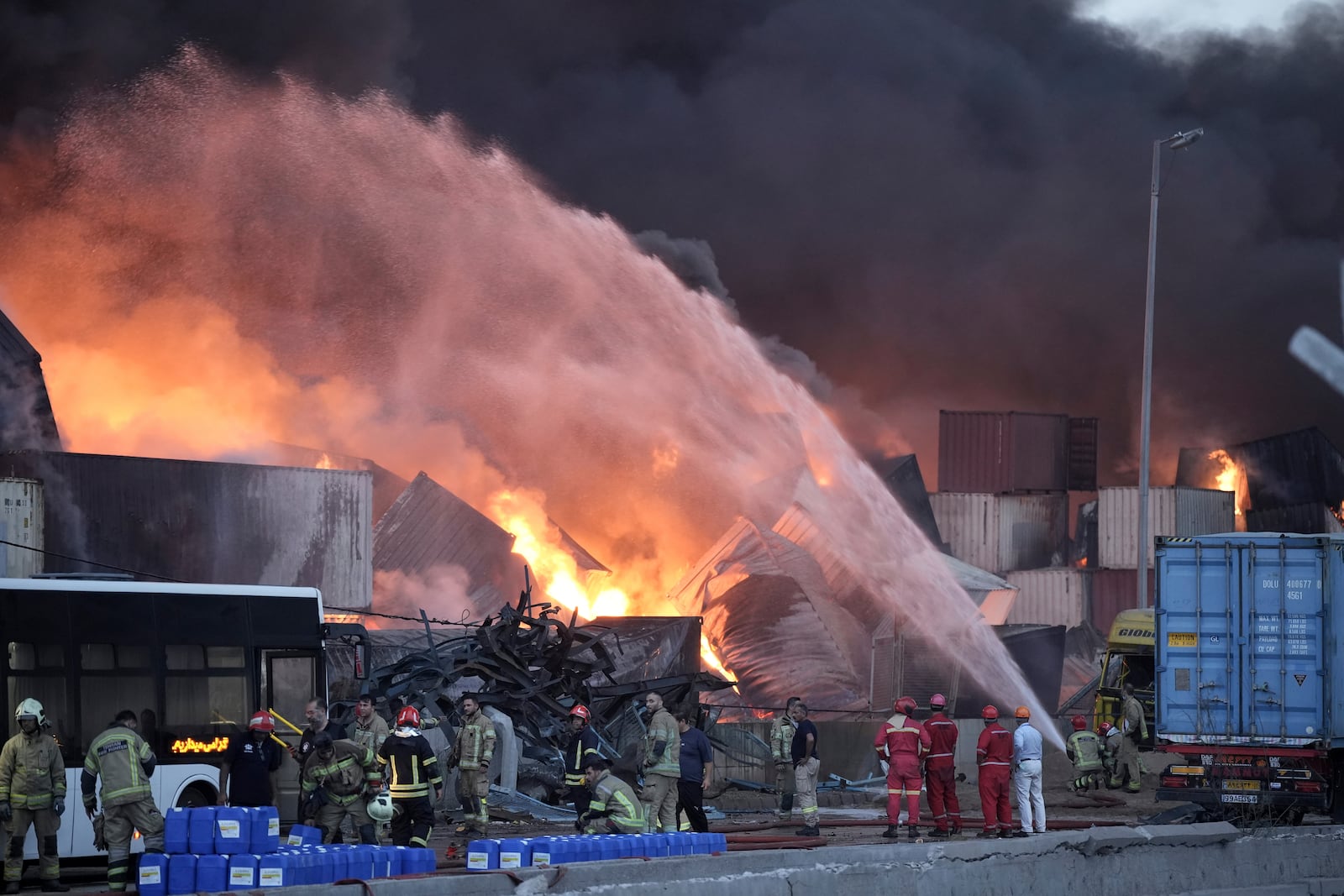 Firefighters try to extinguish the fire, Sunday, April 27, 2025, after a massive explosion and fire rocked a port near the southern port city of Bandar Abbas, Iran, on Saturday. (Mahdi Nori/Fars News Agency via AP)