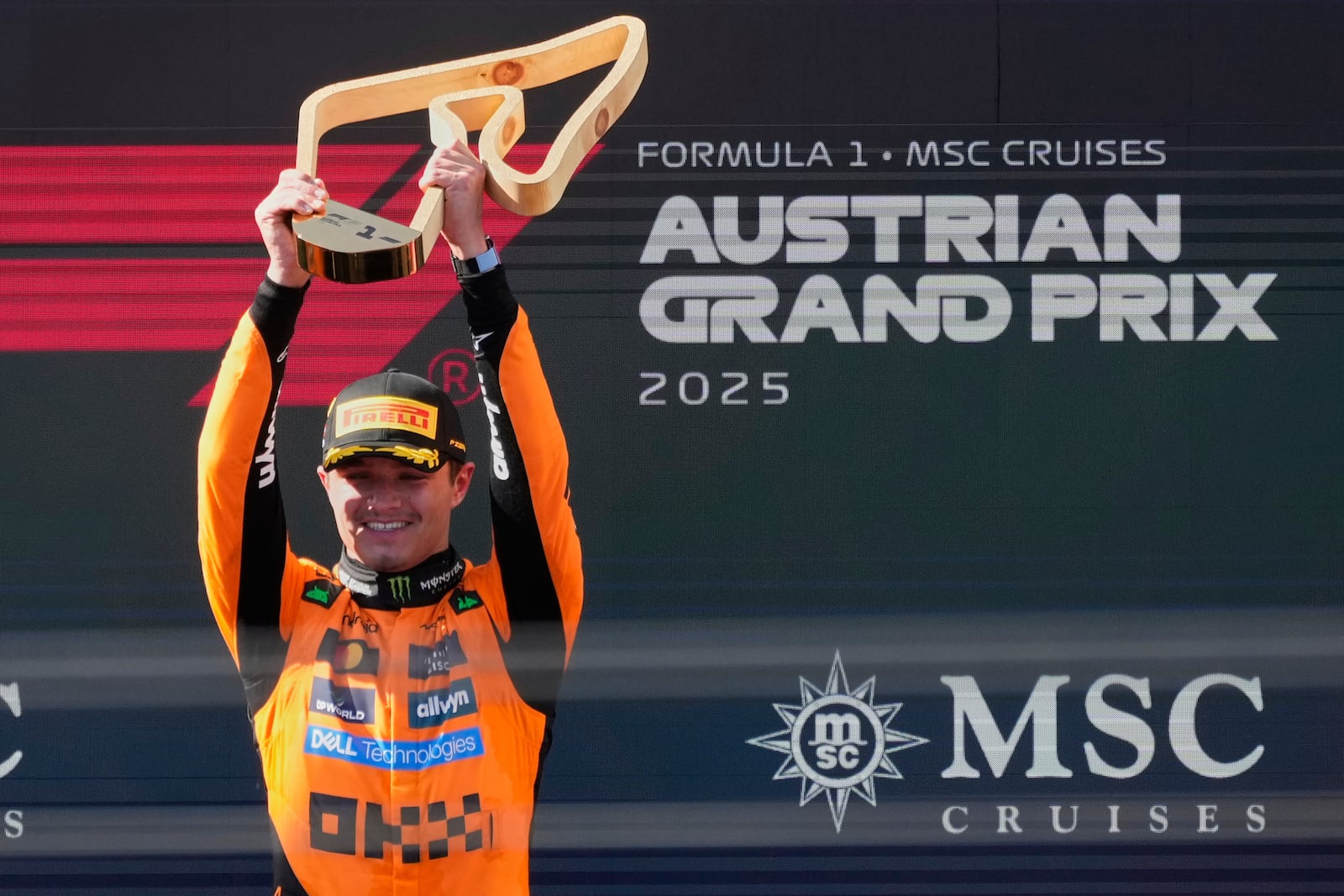 McLaren driver Lando Norris of Britain holds trophy after winning the Austrian Formula One Grand Prix in Spielberg, Austria, Sunday, June 29, 2025. (AP Photo/Darko Bandic)