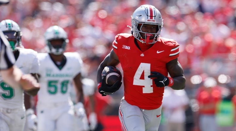 Ohio State receiver Jeremiah Smith, right, breaks away from the Marshall defense to score a touchdown during the second half of an NCAA college football game, Saturday, Sept. 21, 2024, in Columbus, Ohio. (AP Photo/Jay LaPrete)