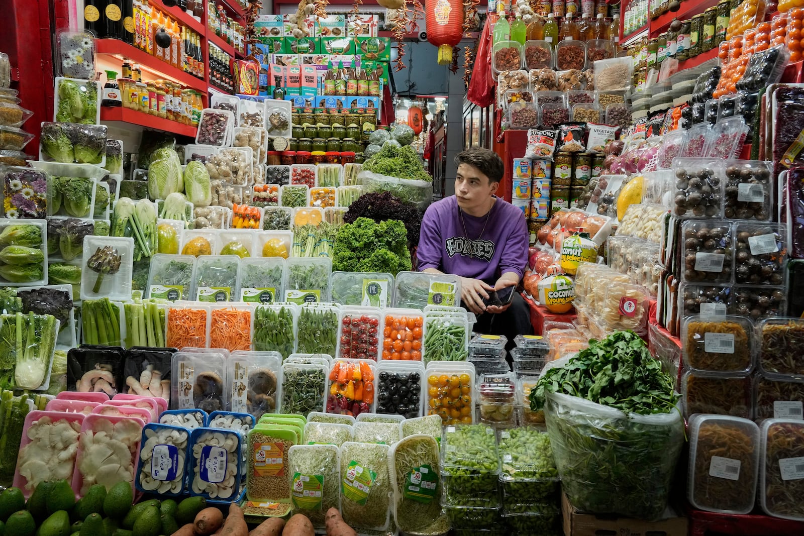 A shopkeeper waits for customers at Tajrish traditional bazaar in northern Tehran, Iran, Friday, June 13, 2025. (AP Photo/Vahid Salemi)