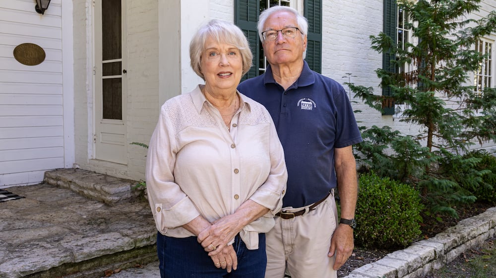 Ed Ross (right) poses with his wife Susan in front of an historic home in Centerville, where he has lived for 20 years. Ross has been named a Dayton Daily News Community Gem for his volunteer work in Centerville, where he is the president of Centerville-Washington History. BRYANT BILLING / STAFF