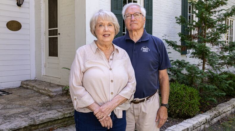 Ed Ross (right) poses with his wife Susan in front of an historic home in Centerville, where he has lived for 20 years. Ross has been named a Dayton Daily News Community Gem for his volunteer work in Centerville, where he is the president of Centerville-Washington History. BRYANT BILLING / STAFF
