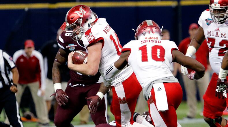 ST. PETERSBURG, FL - DECEMBER 26: Quarterback Gus Ragland #14 of the Miami (Oh) Redhawks tries to jump over a defender during a run in the first quarter against the Mississippi State Bulldogs in the St. Petersburg Bowl at Tropicana Field on December 26, 2016, in St. Petersburg, Florida. (Photo by Joseph Garnett, Jr. /Getty Images)