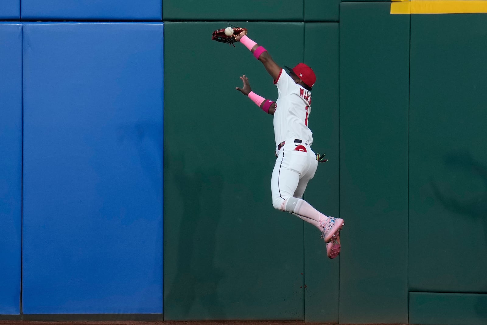 Cleveland Guardians center fielder Angel Martinez (1) jumps for the ball hit for a double by Philadelphia Phillies' J.T. Realmuto in the second inning of a baseball game in Cleveland, Sunday, May 11, 2025. (AP Photo/Sue Ogrocki)