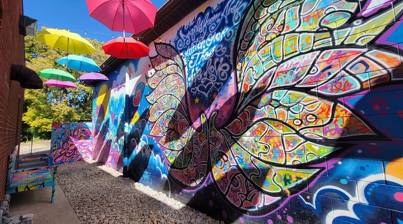 Angel Alley is dedicated in memory of the children from Mason City School District that were lost too soon. The centerpiece of Angel Alley is a large set of angel wings depicted on a wall mural with a colorful umbrella canopy overhead. CONTRIBUTED