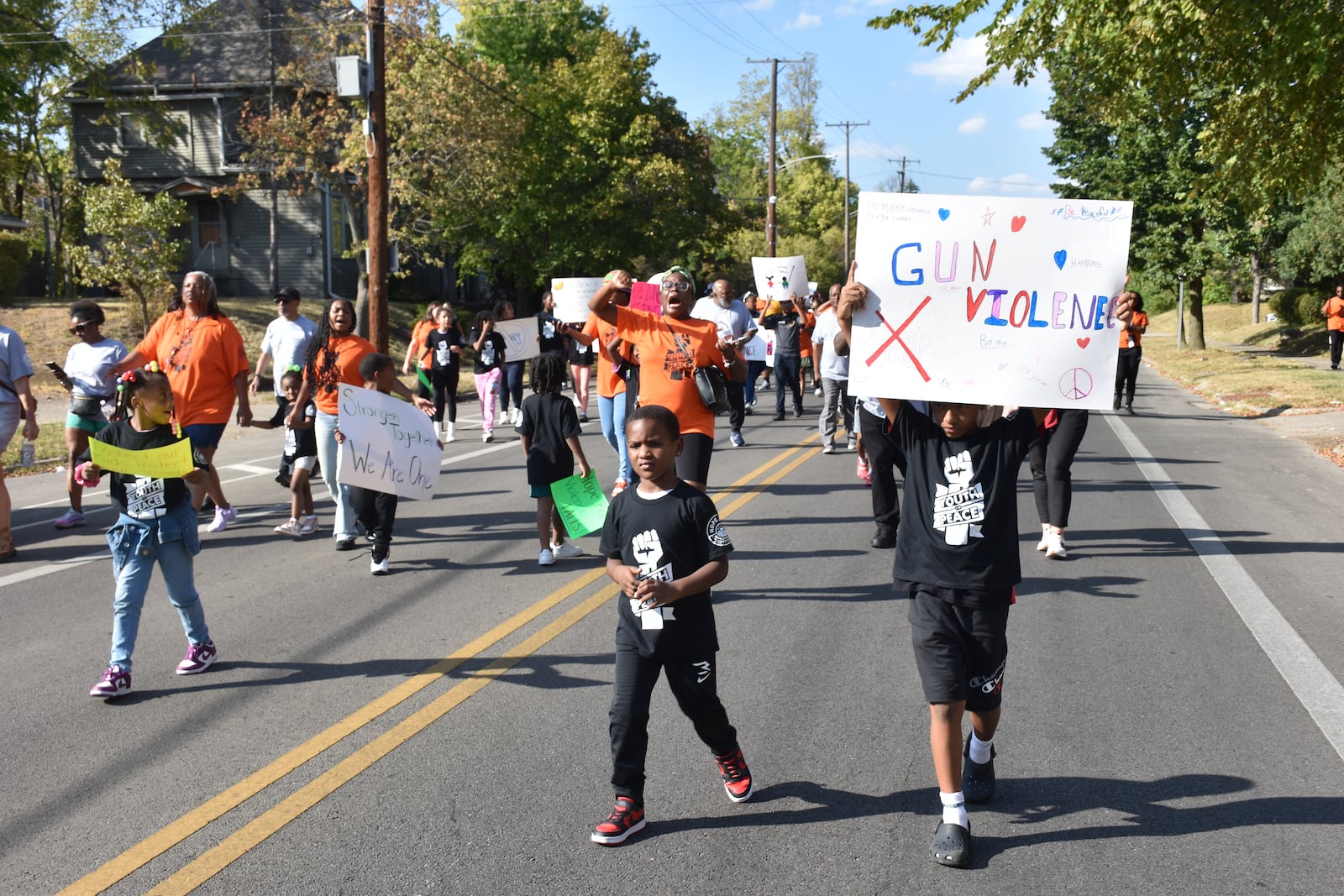 Kids, teens and adults marched down Broadway Street in northwest Dayton on Thursday as part of a peace march and rally in response to an increase in gun violence in the community. CORNELIUS FROLIK / STAFF
