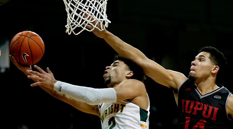 Wright State University guard Tanner Holden tries to score against IUPUI guard Marcus Burk during their Horizon League game at the Nutter Center in Fairborn Sunday, Feb. 16, 2020. Wright State won 106-66. Contributed photo by E.L. Hubbard