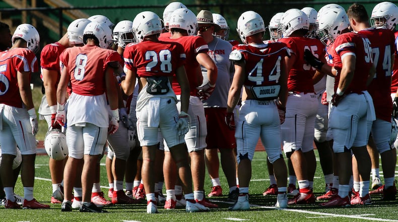 Dayton defensive players huddle at practice on Wednesday, Aug. 17, 2022. David Jablonski/Staff