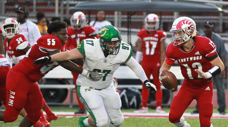 Malachi Oglesby of Trotwood-Madison (left) loses his helmet while blocking Hunter Parks of Northmont and protecting Rams QB Cooper Stewart. Trotwood defeated visiting Northmont 20-14 in a Week 5 high school football game on Friday, Sept. 27, 2019. MARC PENDLETON / STAFF