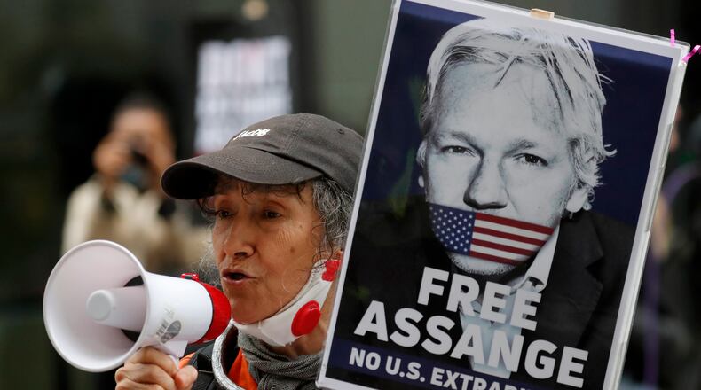 Julian Assange supporters protest outside the Old Bailey in London, Monday, Sept. 7, 2020. Lawyers for WikiLeaks founder Julian Assange and the U.S. government were squaring off in a London court on Monday at a high-stakes extradition case delayed by the coronavirus pandemic. American prosecutors have indicted the 49-year-old Australian on 18 espionage and computer misuse charges over the WikiLeaks publication of secret U.S. military documents a decade ago. The charges carry a maximum sentence of 175 years in prison. (AP Photo/Frank Augstein)