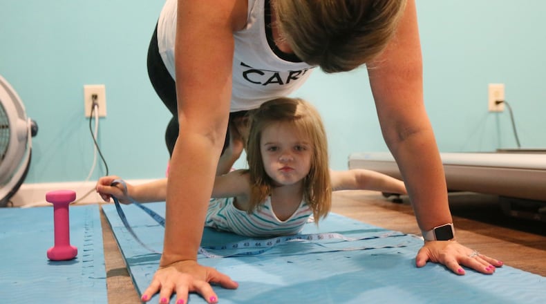 A few simple pieces of equipment like mats, dumbbells and resistance bands can help you keep in shape when you’re short on time or the kids are home all day for the summer. (Chris Lee/St. Louis Post-Dispatch/TNS)