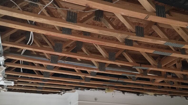 The ceiling drywall to a second-floor apartment was removed to expose structural damages at the Province Apartments in Bath Twp., Greene County.