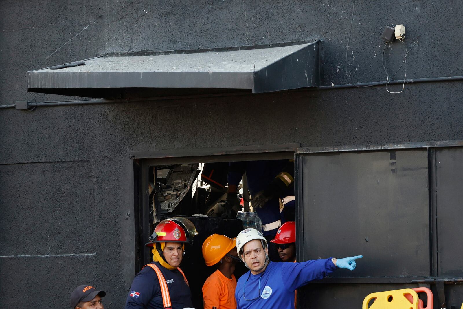 Rescue workers search for survivors at the Jet Set nightclub after its roof collapsed during a merengue concert in Santo Domingo, Dominican Republic, Tuesday, April 8, 2025. (AP Photo/Eddy Vittini)