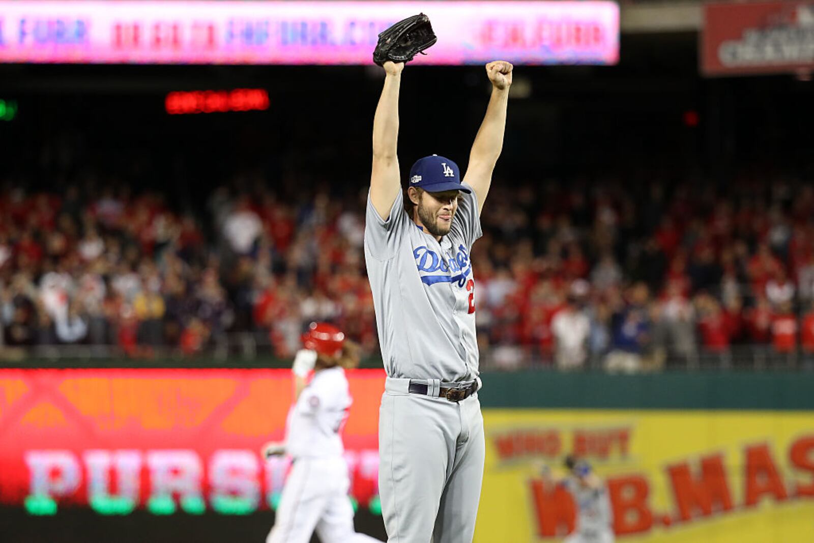 WASHINGTON, DC - OCTOBER 13: Clayton Kershaw #22 of the Los Angeles Dodgers celebrates after winning game five of the National League Division Series over the Washington Nationals 4-3 at Nationals Park on October 13, 2016 in Washington, DC. (Photo by Rob Carr/Getty Images)