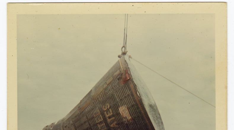 This 1966 image taken by Ron McQueeney shows the Gemini 8 spacecraft being lifted for transport at Naha Air Base in Okinawa, Japan. (Ron McQueeney/Ohio History Connection via AP)