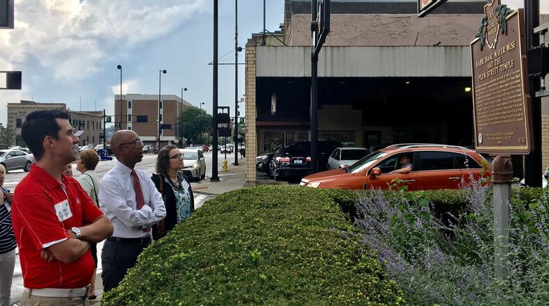 OSU president Michael Drake and other Ohio State Roads Scholars look at a historical marker for Isaac Wise Plum Street Temple in downtown Cincinnati.