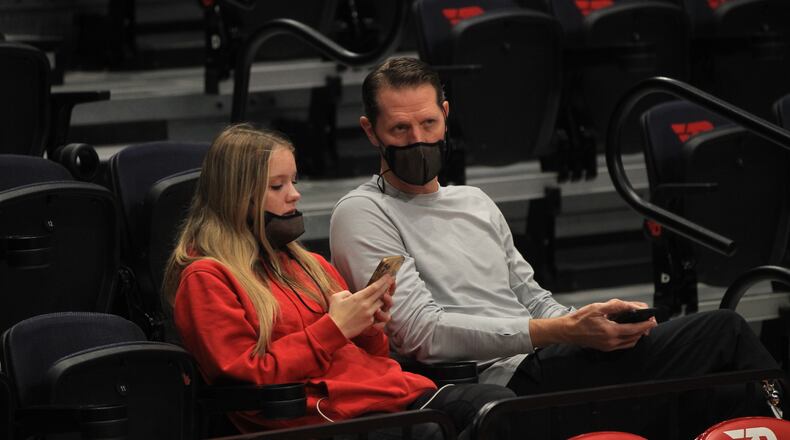 Former Cincinnati and Northern Kentucky coach John Brannen sits behind the Dayton bench before an exhibition game against Cedarville on Monday, Nov. 1, 2021, at UD Arena. David Jablonski/Staff
