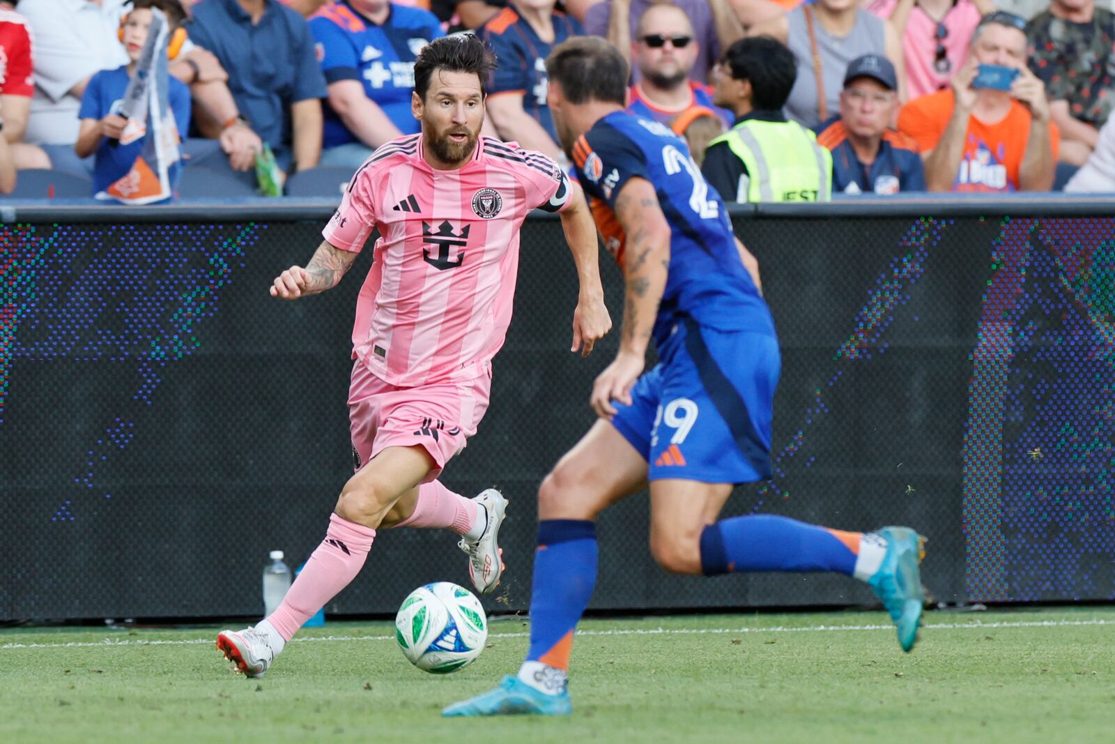 Inter Miami's Lionel Messi, left, dribbles the ball as FC Cincinnati's Lukas Engel defends during the first half of an MLS soccer match, Wednesday, July 16, 2025, in Cincinnati. (AP Photo/Jay LaPrete)