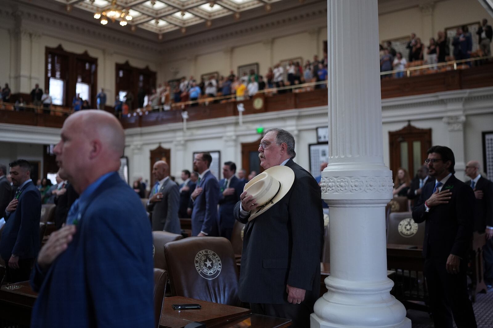 Texas State Rep. Cecil Bell, Jr., R-Magnolia, center and other house member stand for the pledge as the House calls a Special Session, Monday, July 21, 2025, in Austin. (AP Photo/Eric Gay)