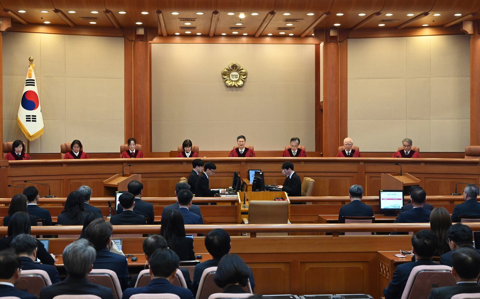 Moon Hyung-bae, center, acting chief justice of South Korea's Constitutional Court, speaks during the final ruling of South Korean President Yoon Suk Yeol's impeachment at the Constitutional Court on Friday, April 4, 2025 in Seoul, South Korea. (Kim Min-Hee, Japan Pool/Kyodo News via AP)