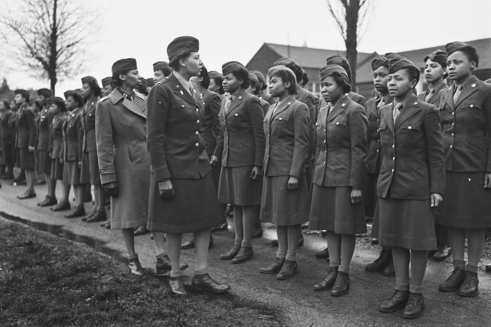 In this photo provided by the National Archives, Maj. Charity E. Adams and Capt. Mary Kearney, of the 6888th Central Postal Directory Battalion, inspect the first contingent of Black members of the Women's Army Corps assigned to overseas service in England on Feb. 15, 1945. (Holt/U.S. Army via AP)