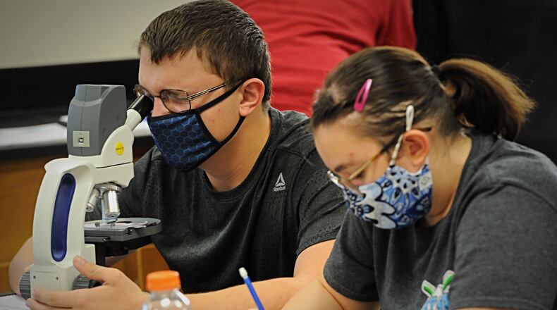 Beavercreek High School students work in a science class Oct. 8. The district will switch on Oct. 19 to a hybrid plan where students are divided into two groups, with each student attending school in-person only two days per week.