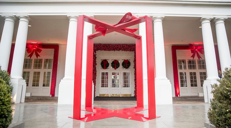 FILE - A large ribbon is displayed outside the East Wing of the White House during a preview of the 2016 holiday decor, Nov. 29, 2016, in Washington. (AP Photo/Andrew Harnik, File)