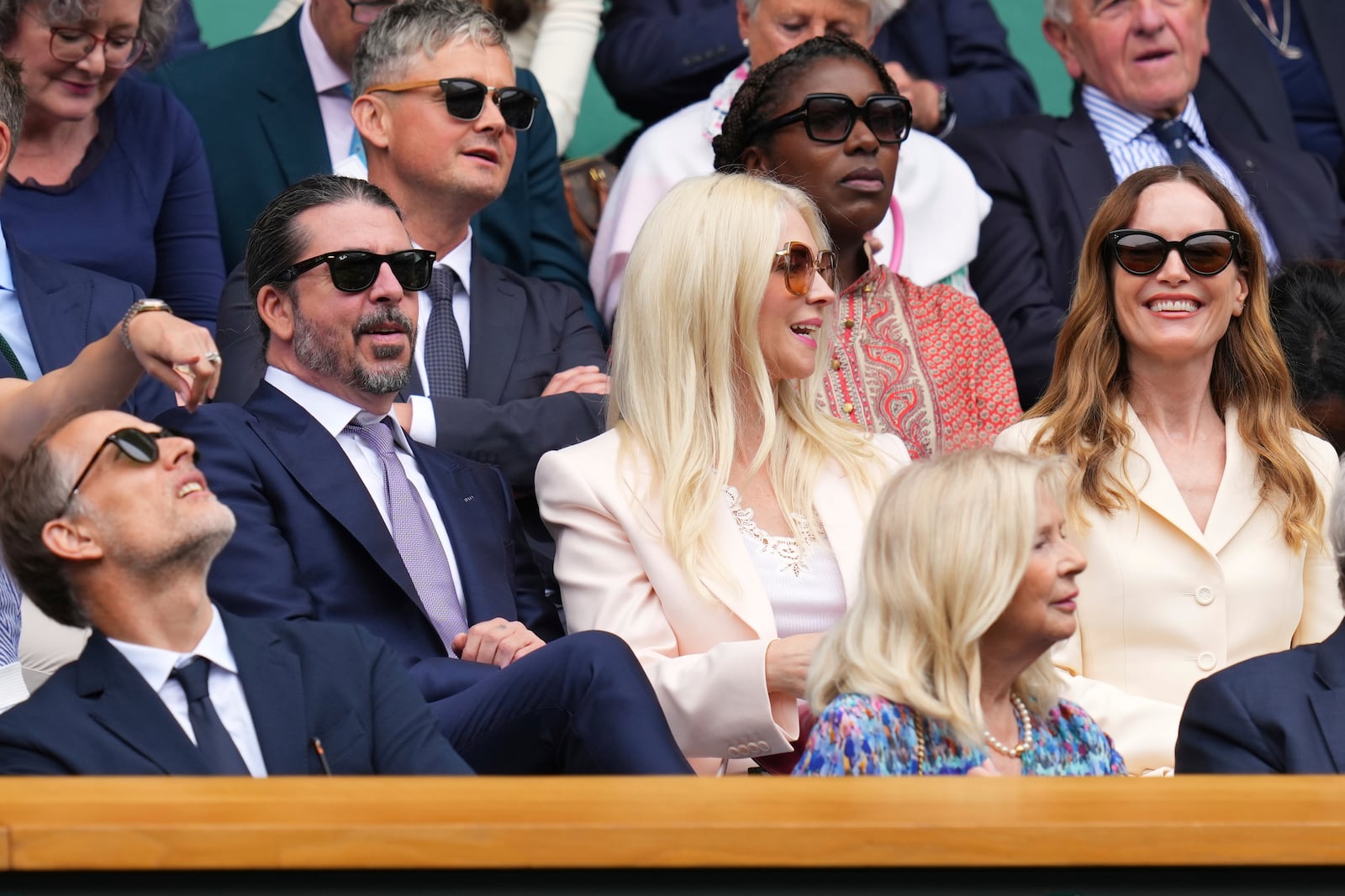 Musician Dave Grohl his wife Jordyn, centre, and actor Leslie Mann sit in the Royal Box at Centre Court during the Wimbledon Tennis Championships in London, Wednesday, July 2, 2025.(AP Photo/Kirsty Wigglesworth)