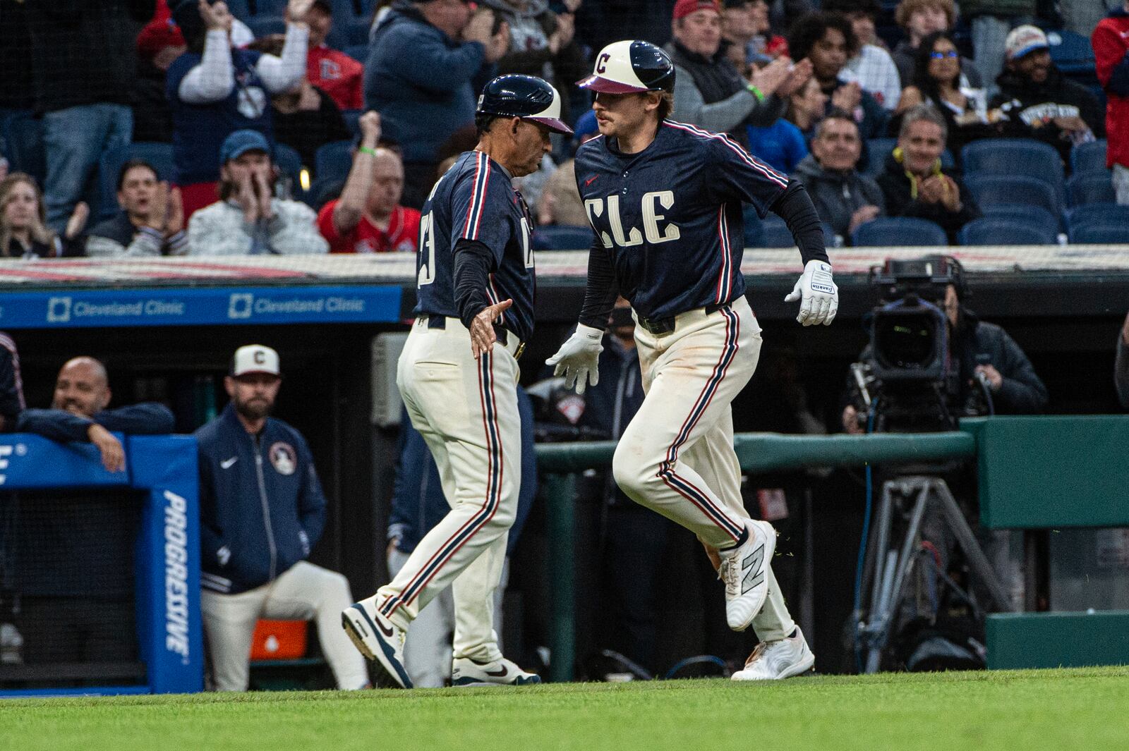 Cleveland Guardians' Kyle Manzardo, right, is congratulated by third base coach Rouglas Odor after hitting a solo home run off Philadelphia Phillies starting pitcher Aaron Nola during the fourth inning of a baseball game Friday, May 9, 2025, in Cleveland. (AP Photo/Phil Long)