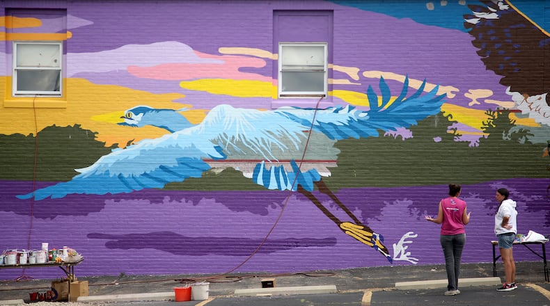 A new large-scale mural with an outdoor theme is underway on the south side of the Printpoint Printing building, 150 S. Patterson Blvd. The mural, entitled "Twighlight," is designed by artist Gae Helton. It is being produced by the K12 Gallery & TEJAS and artists in the Montgomery County Juvenile Court's HAALO Program. LISA POWELL / STAFF