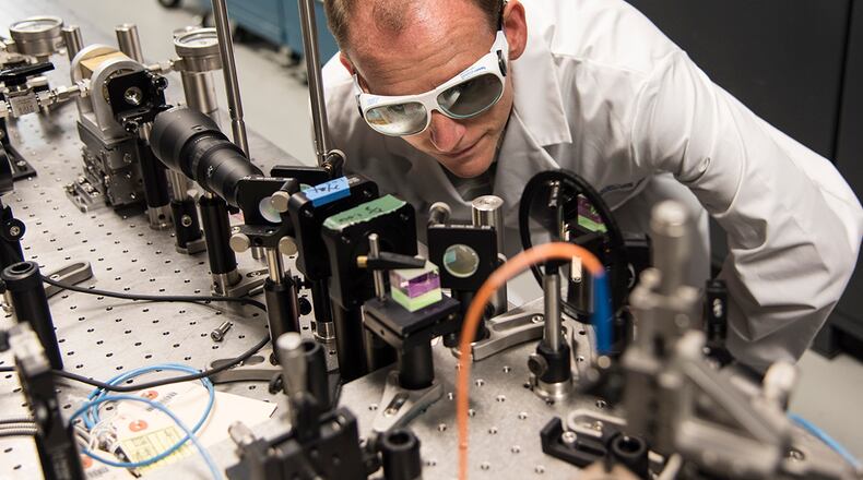 Dr. Christian Keyser at the Air Force Research Laboratory Munitions Directorate, Eglin Air Force Base, Florida, examines laboratory equipment designed to study the way that weapon seeker optics detect light. CONTRIBUTED PHOTO