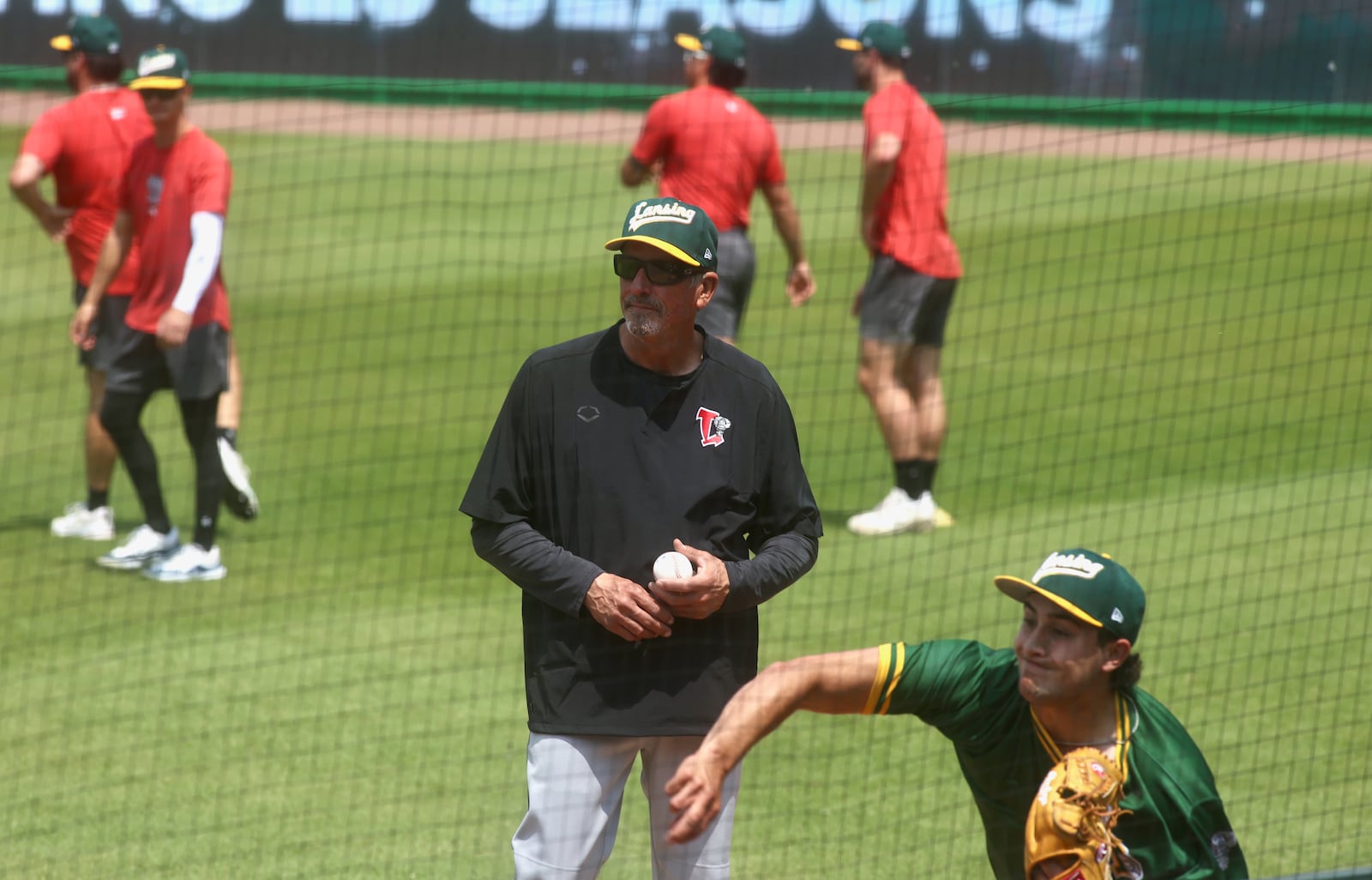 Former big-league pitcher Dave Burba, a graduate of Kenton Ridge High School, watches a pitcher warm up before a game at Day Air Ballpark in Dayton on Tuesday, June 3, 2025. Burba is the pitching coach for the Lansing Lugnuts. David Jablonski/Staff