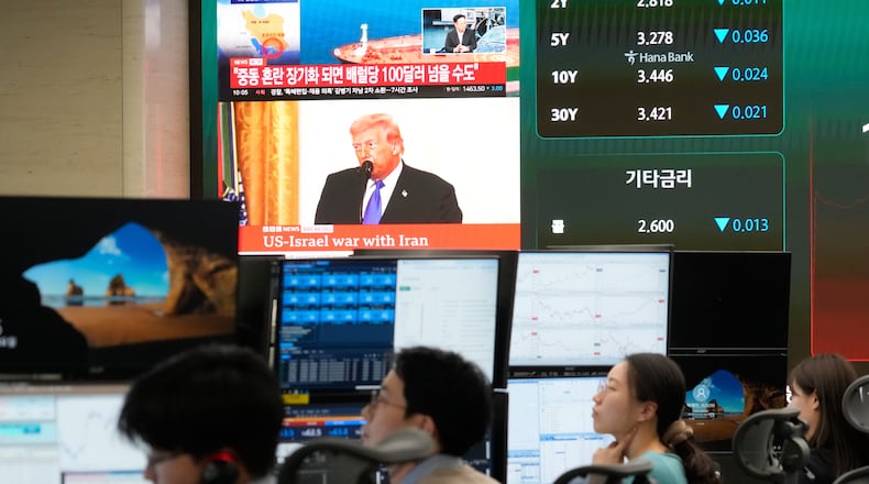 U.S. President Donald Trump is seen on a screen as traders work at the foreign exchange dealing room of the Hana Bank headquarters in Seoul, South Korea, Tuesday, March 3, 2026. (AP Photo/Ahn Young-joon)